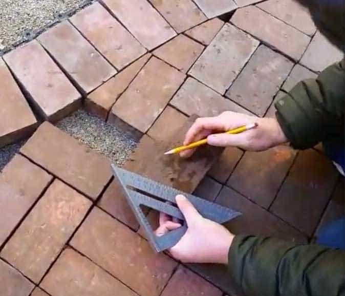 marking line to cut the brick with wet tile saw